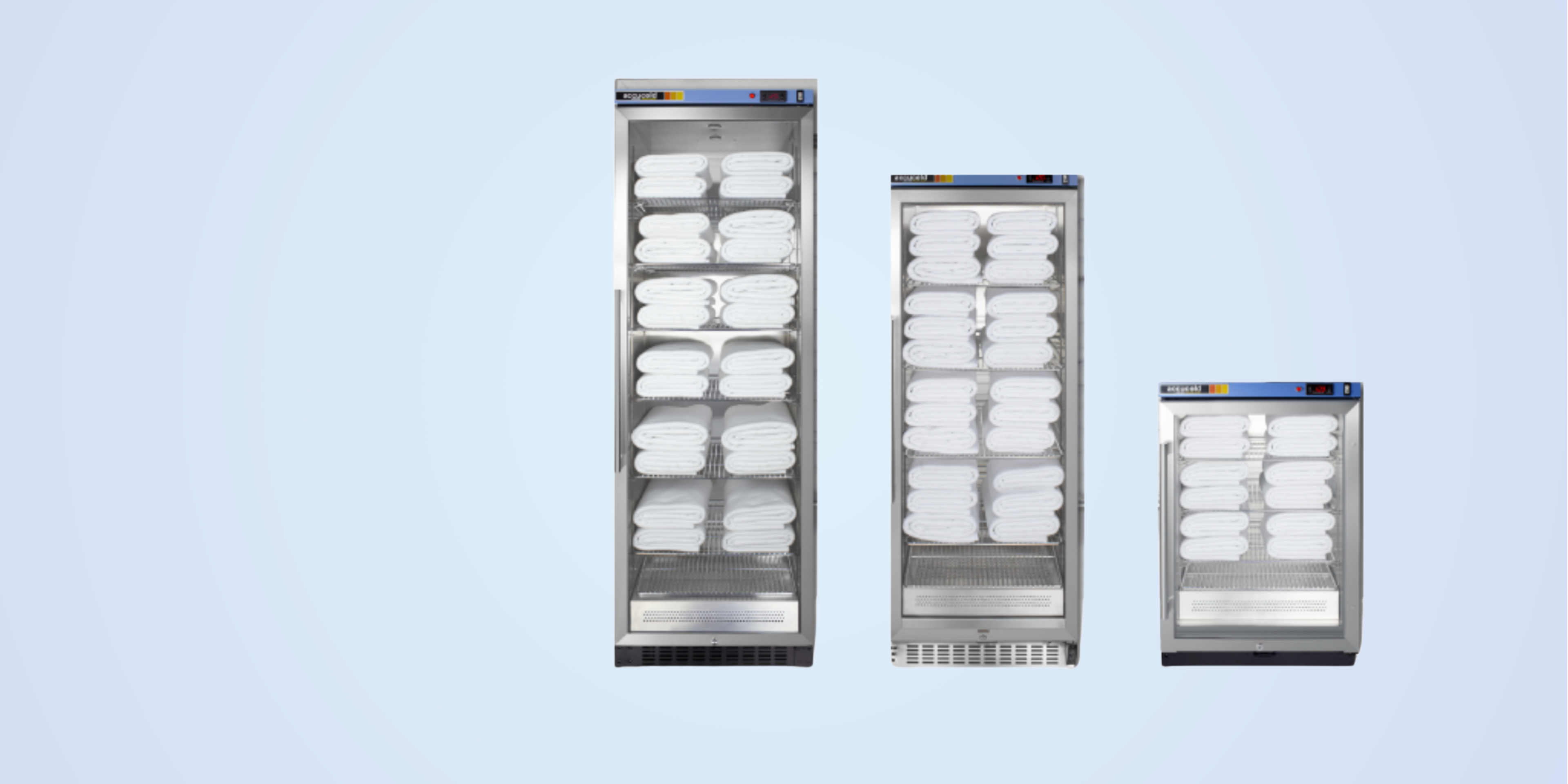 Three vertical storage units with white towels on a light blue background