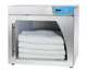Enthermics warmer with folded white cloths inside on a white background