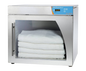 Enthermics warmer with folded white cloths inside on a white background