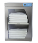 Stainless steel towel warmer with folded white towels inside on a white background