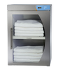 Stainless steel towel warmer with folded white towels inside on a white background